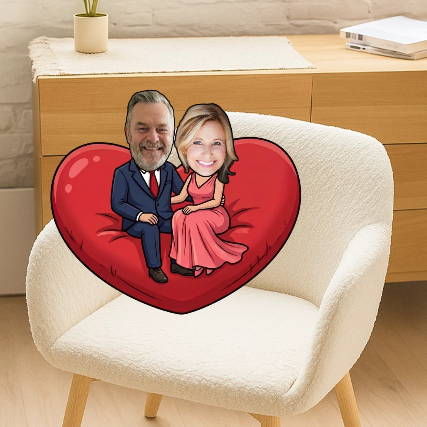 Heart-shaped pillow with cartoon faces of a man and woman on a white chair.