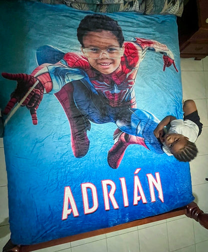 kid with his spider-man blanket on a bed