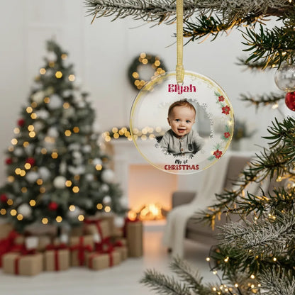 Personalized Christmas ornament with a child's photo and name, hanging on a decorated tree.